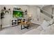 Spacious living room featuring neutral-toned furniture and a large TV above a media console at 7585 Sunny Dreams Ln, Kissimmee, FL 34747