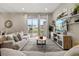 Open living area with comfortable seating, a coffee table, and sliding glass doors to the backyard at 7585 Sunny Dreams Ln, Kissimmee, FL 34747