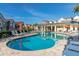 Resort-style pool with lounge chairs and clubhouse at 7585 Sunny Dreams Ln, Kissimmee, FL 34747