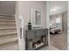 View of a carpeted staircase and entryway with a console table and mirror at 7585 Sunny Dreams Ln, Kissimmee, FL 34747