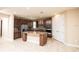 Island kitchen with granite countertops and wood cabinets at 7845 Wandering Way, Orlando, FL 32836