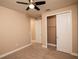 Well-lit bedroom featuring ceiling fan and ample closet space at 7845 Wandering Way, Orlando, FL 32836