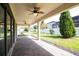 Spacious covered patio with paver flooring and ceiling fans at 7845 Wandering Way, Orlando, FL 32836