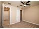 Bedroom with ceiling fan and access to hallway at 7845 Wandering Way, Orlando, FL 32836