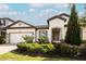 Single-story home with a two-car garage and landscaped yard at 7845 Wandering Way, Orlando, FL 32836
