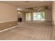 Spacious living area with carpeting and high ceilings at 7845 Wandering Way, Orlando, FL 32836