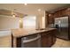 Island kitchen with granite countertops and stainless steel dishwasher at 7845 Wandering Way, Orlando, FL 32836