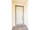 White front door with keyless entry and sidelights at 7845 Wandering Way, Orlando, FL 32836