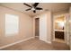 Bedroom with ceiling fan, closet, and en-suite bathroom access at 7845 Wandering Way, Orlando, FL 32836
