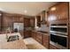 Open kitchen with stainless steel appliances and granite countertops at 7845 Wandering Way, Orlando, FL 32836