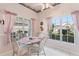 Charming breakfast nook with glass table and pink accents, overlooks backyard at 247 Travis Ln, Davenport, FL 33837