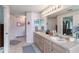 Double vanity bathroom with a large mirror and access to the bedroom at 247 Travis Ln, Davenport, FL 33837