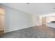 Large living room with gray tile floors and an open concept kitchen at 2971 Camden Way, Davenport, FL 33837