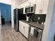 Modern kitchen with stainless steel appliances and gray countertops at 2971 Camden Way, Davenport, FL 33837