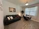 Living room features gray couch, round dining table, and patterned rug at 2971 Camden Way, Davenport, FL 33837