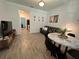 Open living room with gray sofa, dining table, and wood-look tile floors at 2971 Camden Way, Davenport, FL 33837