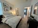 Bedroom with a bed, nightstands, and modern wall art at 2971 Camden Way, Davenport, FL 33837