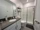 Stylish bathroom with gray vanity, walk-in shower, and toilet at 2971 Camden Way, Davenport, FL 33837