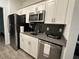 Modern kitchen with stainless steel appliances and gray countertops at 2971 Camden Way, Davenport, FL 33837
