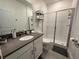 Updated bathroom with gray vanity, walk-in shower, and toilet at 2971 Camden Way, Davenport, FL 33837