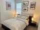 Bedroom with a bed, nightstands, and modern wall art at 2971 Camden Way, Davenport, FL 33837