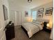 Bedroom with a bed, nightstands, and modern wall art at 2971 Camden Way, Davenport, FL 33837