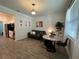 Open living room with gray sofa, dining table, and wood-look tile floors at 2971 Camden Way, Davenport, FL 33837