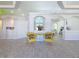 Open living area with a sitting area and yellow chairs at 3221 Bayview Ln, St Cloud, FL 34772