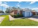 Front view of a light blue and brick home with garage at 3401 Home Town Ln, St Cloud, FL 34769