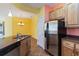 Kitchen with stainless steel appliances and light wood cabinets at 3401 Home Town Ln, St Cloud, FL 34769