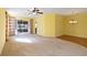 Open living room with neutral carpeting and view into dining area at 3401 Home Town Ln, St Cloud, FL 34769