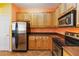 Kitchen with stainless steel appliances and light wood cabinets at 3401 Home Town Ln, St Cloud, FL 34769