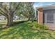 Landscaped backyard with mature trees and green grass at 3401 Home Town Ln, St Cloud, FL 34769
