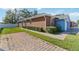 Side view of a light blue and brick home with a garage at 3401 Home Town Ln, St Cloud, FL 34769