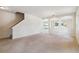Large living room with carpeted floors and a staircase at 3804 Marietta Way, St Cloud, FL 34772