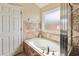 Bathroom features an oval tub and patterned tile surround at 3804 Marietta Way, St Cloud, FL 34772