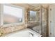 Relax in this bathroom with a garden tub and patterned tile shower at 3804 Marietta Way, St Cloud, FL 34772