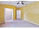Spacious bedroom with neutral walls and carpet, featuring a walk-in closet and ceiling fan at 3804 Marietta Way, St Cloud, FL 34772