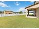 Large backyard with covered patio and grassy area, perfect for entertaining at 3804 Marietta Way, St Cloud, FL 34772