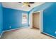 Blue-walled bedroom with ceiling fan and neutral carpeting at 3804 Marietta Way, St Cloud, FL 34772