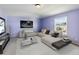 Bedroom with lavender walls and staged furniture at 3804 Marietta Way, St Cloud, FL 34772