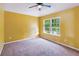 Bedroom with yellow walls, a large window, and neutral carpeting at 3804 Marietta Way, St Cloud, FL 34772