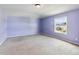 Bedroom with lavender walls and a window at 3804 Marietta Way, St Cloud, FL 34772
