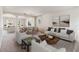Living room with staged furniture and large windows at 3804 Marietta Way, St Cloud, FL 34772