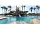 Large community pool with waterslide and palm trees at 3907 Golden Knot Dr, Kissimmee, FL 34746