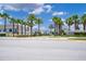 Landscaped entrance to Windsor at Westside with palm trees and townhomes visible at 8912 Sydney Ave, Kissimmee, FL 34747