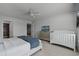 King bedroom with white bed frame, gray walls, and crib at 8912 Sydney Ave, Kissimmee, FL 34747