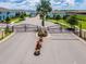 Gated entrance to community with landscaping at 8912 Sydney Ave, Kissimmee, FL 34747