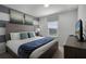 King bedroom with wood bed frame and gray and teal decor at 8912 Sydney Ave, Kissimmee, FL 34747