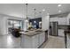 Modern kitchen with island, stainless steel appliances and open floor plan at 8912 Sydney Ave, Kissimmee, FL 34747